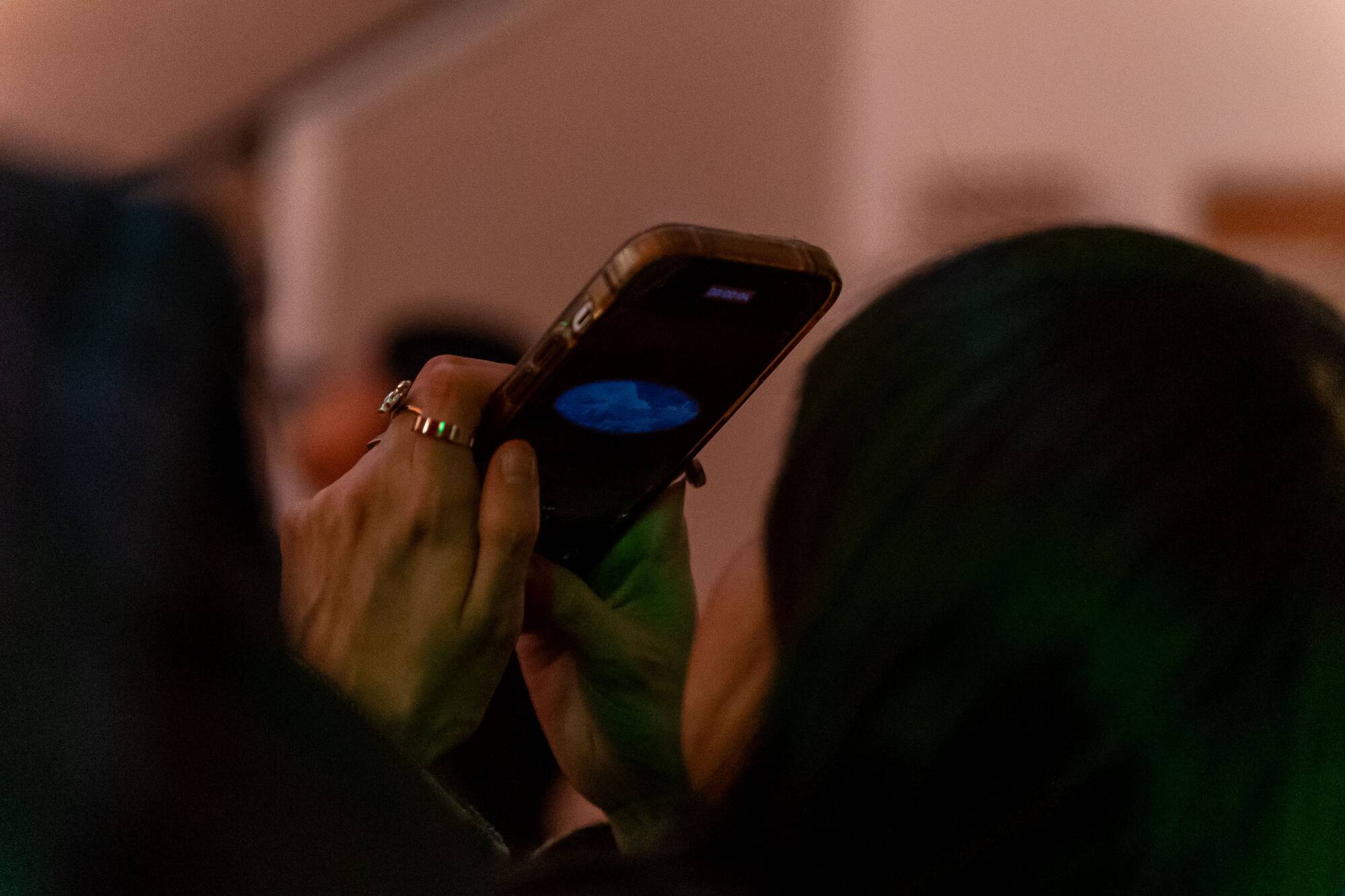 An audience member's phone pointed up towards the ceiling, recording the performance